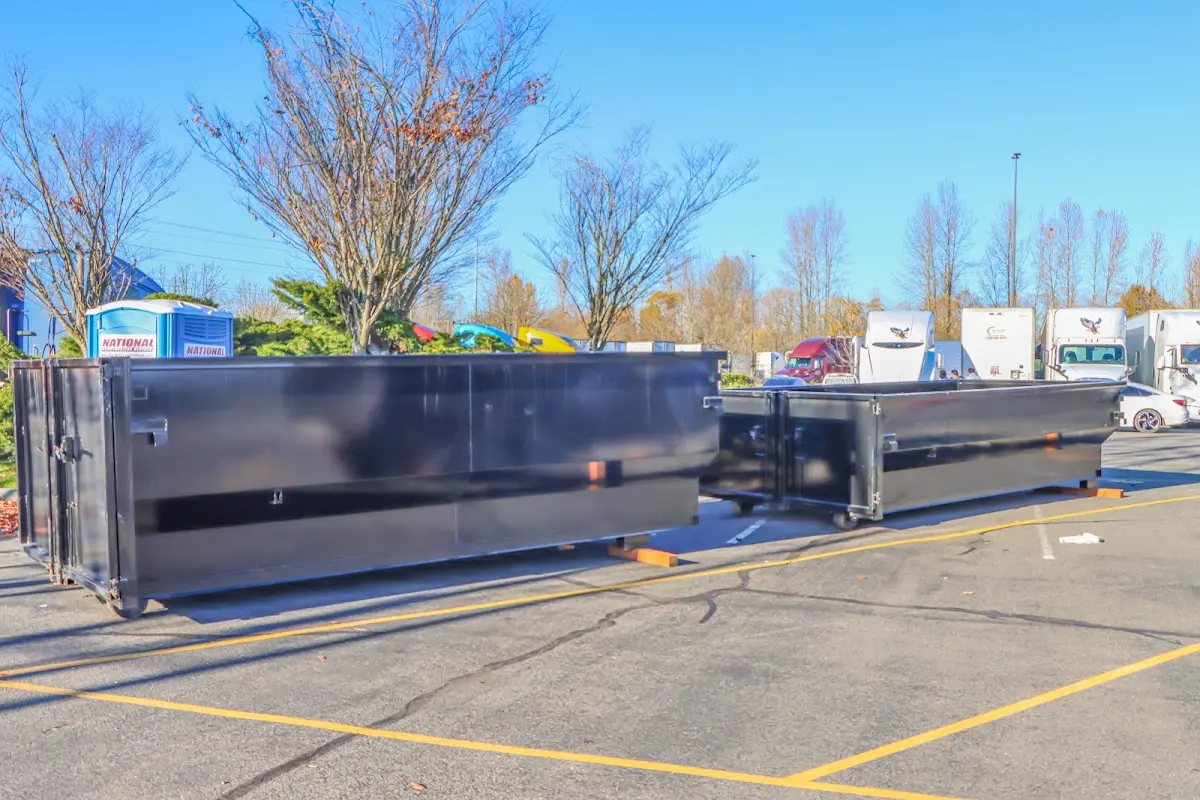 Professional dumpster rental service with roll-off container on residential driveway in Crossville